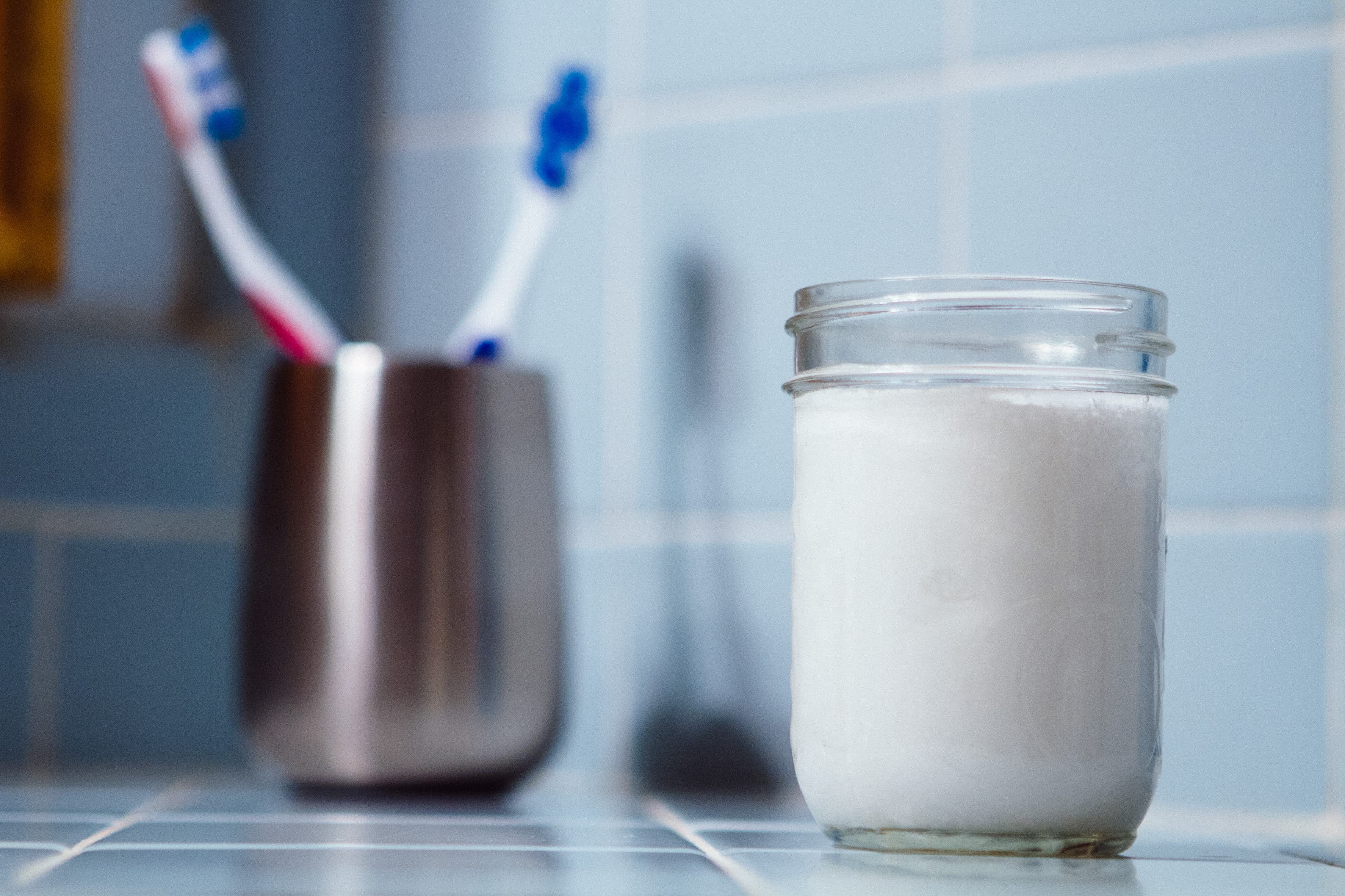 DIY toothpaste in jar with brushes