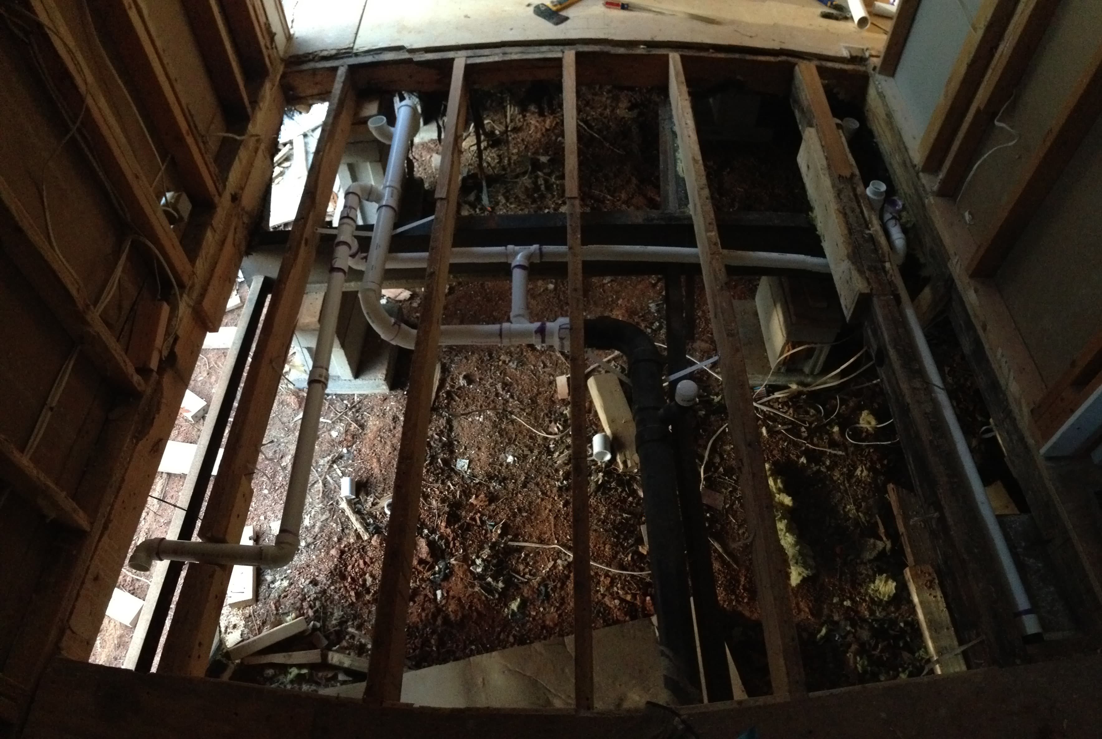 Looking into a large hole. All the subfloor has been removed from this room.