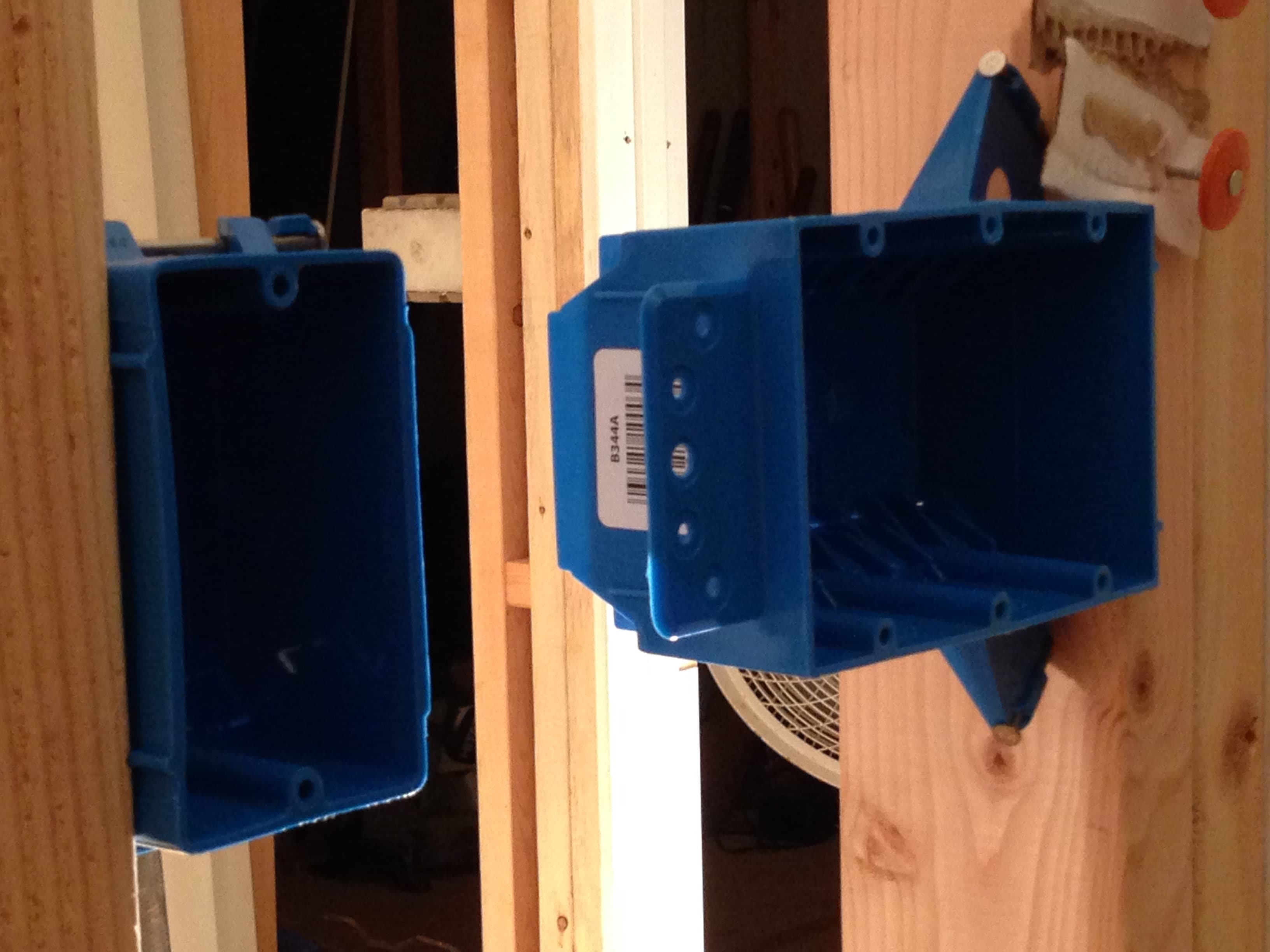 Plastic electrical boxes hung on the wall