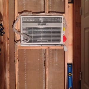 AC unit mounted in the boys bedroom wall on the homestead
